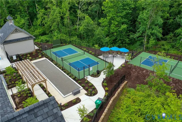 an aerial view of a house with garden space and street view