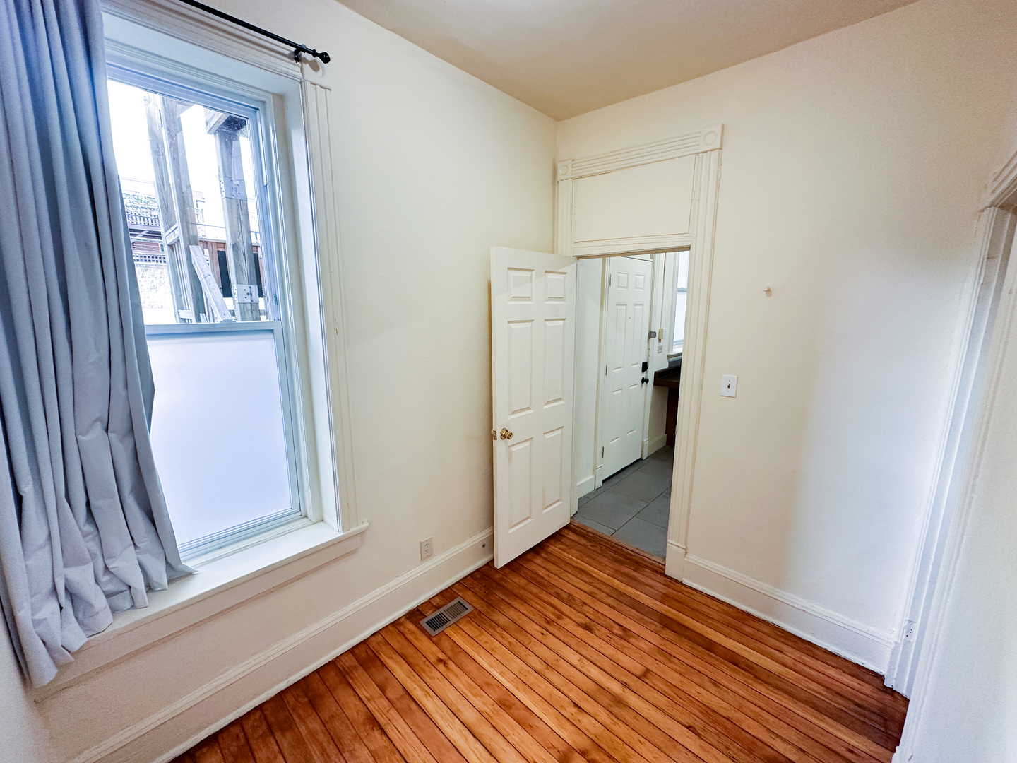 2126 North Sheffield Avenue, Unit 1 Chicago, IL 60614 - Photo 13 of 24 a view of an empty room with wooden floor and a window