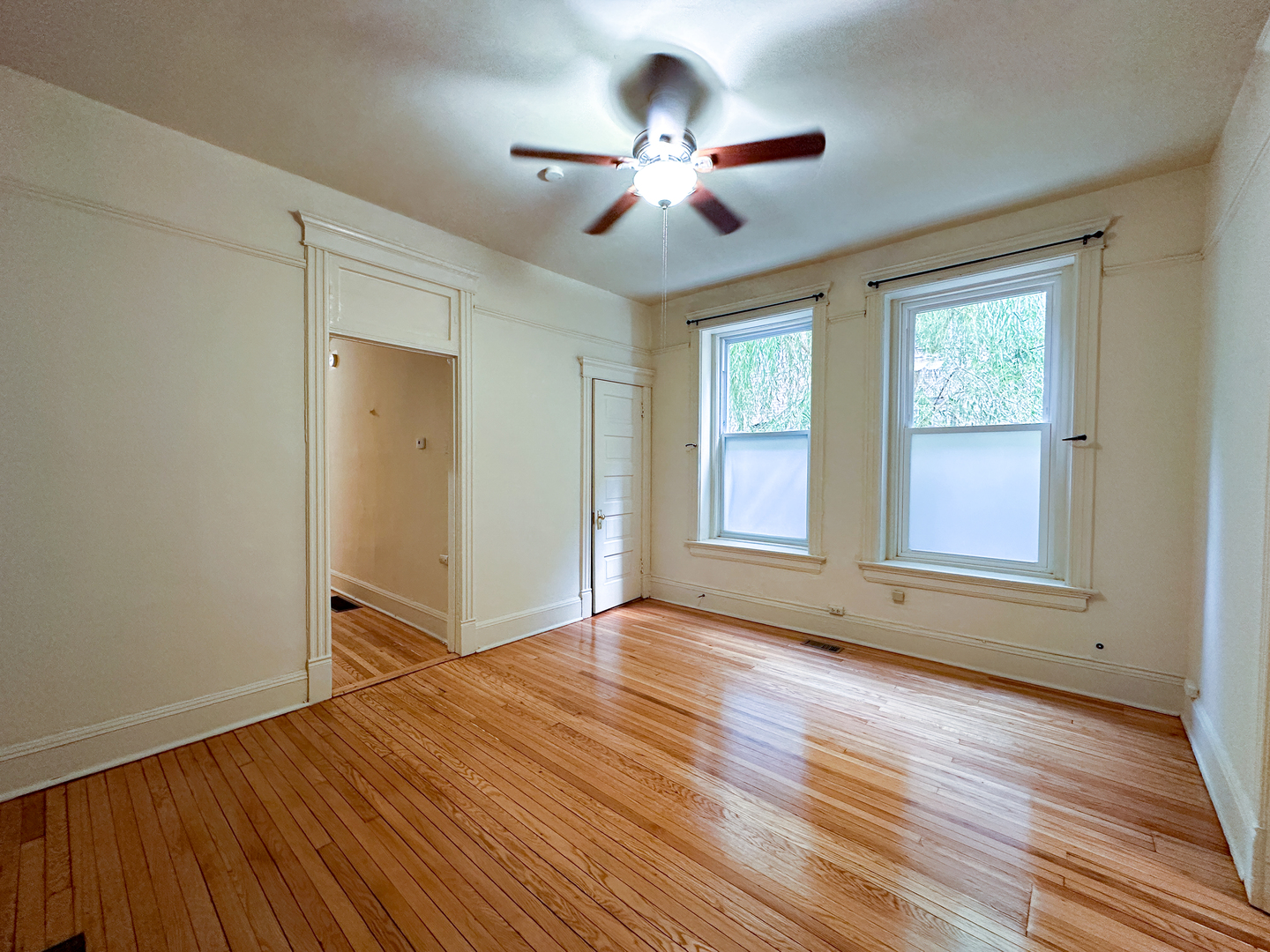 2126 North Sheffield Avenue, Unit 1 Chicago, IL 60614 - Photo 19 of 24 a view of an empty room with wooden floor and a window