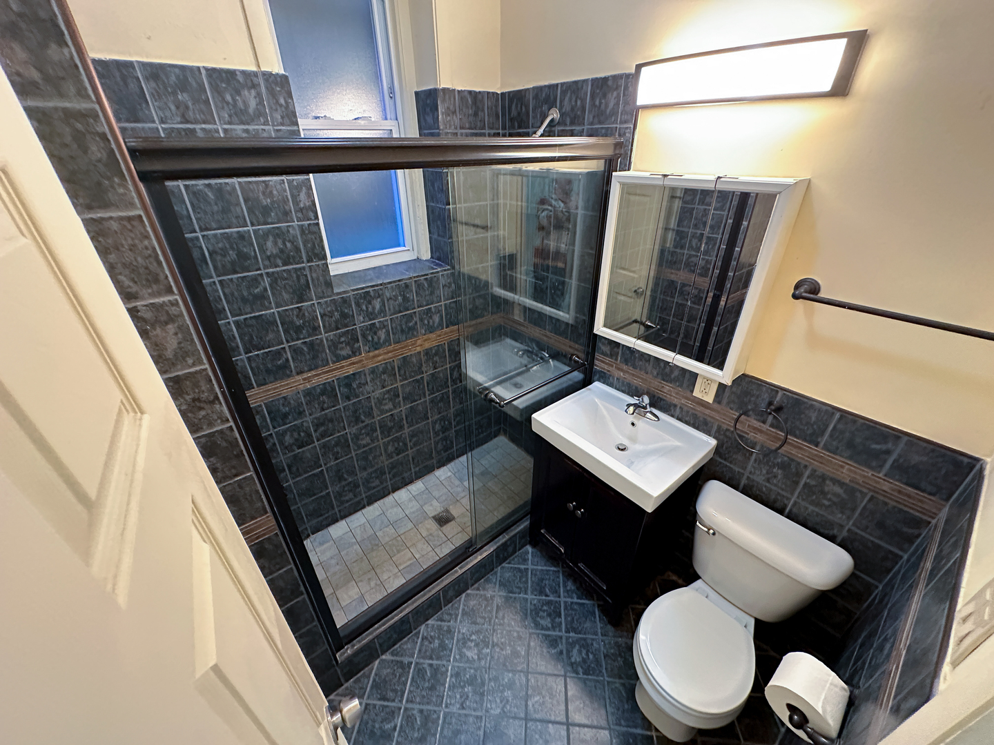 2126 North Sheffield Avenue, Unit 1 Chicago, IL 60614 - Photo 3 of 24 a bathroom with a toilet a sink and a mirror