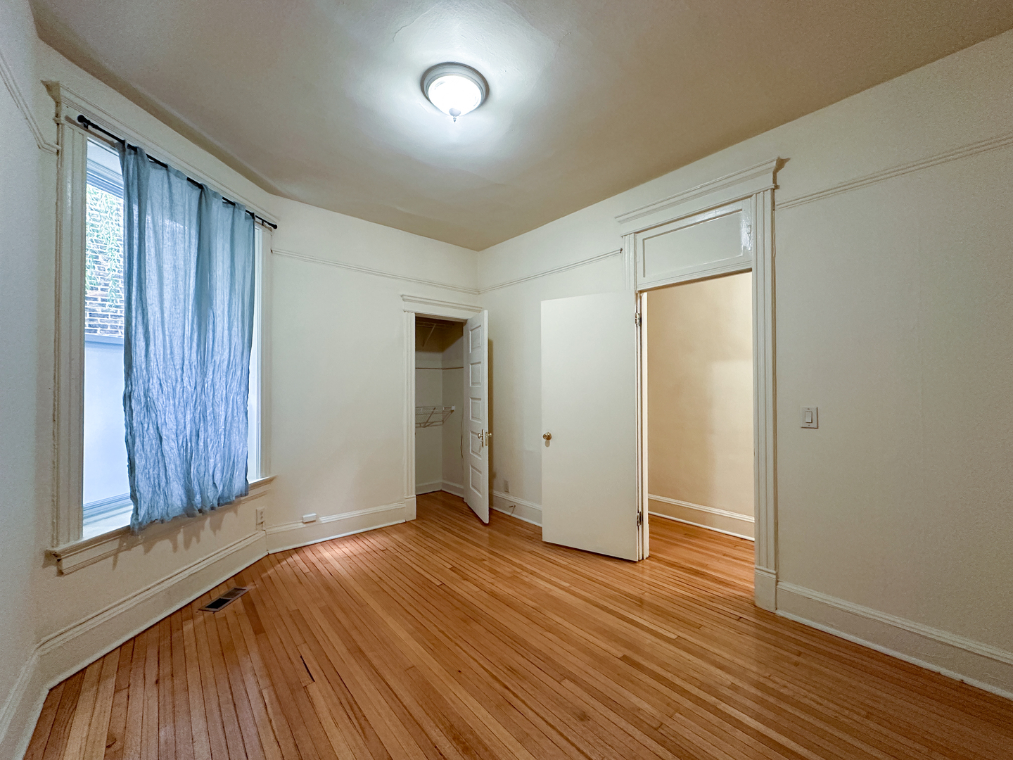 2126 North Sheffield Avenue, Unit 1 Chicago, IL 60614 - Photo 5 of 24 an empty room with closet and wooden floor