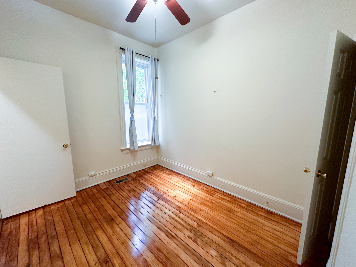 2126 North Sheffield Avenue, Unit 1 Chicago, IL 60614 - Photo 9 of 24 an empty room with wooden floor and windows
