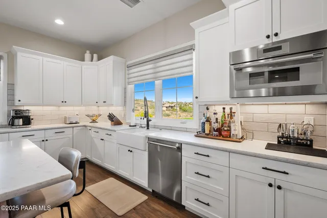 a spacious bedroom with a bed and a flat screen tv