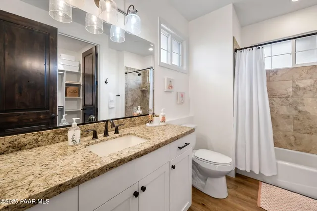 a view of a patio with couches and table and chairs and potted plants