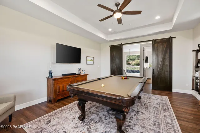 a view of a patio with table and chairs potted plants and a large window