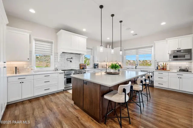 a kitchen with stainless steel appliances a stove and a refrigerator