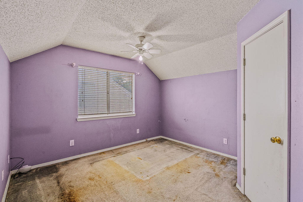 53 4th Street Shalimar, FL 32579 - Photo 23 of 47 an empty room with a chandelier fan and windows