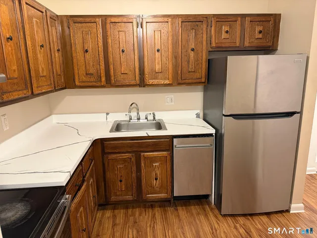a white refrigerator freezer sitting inside of a kitchen