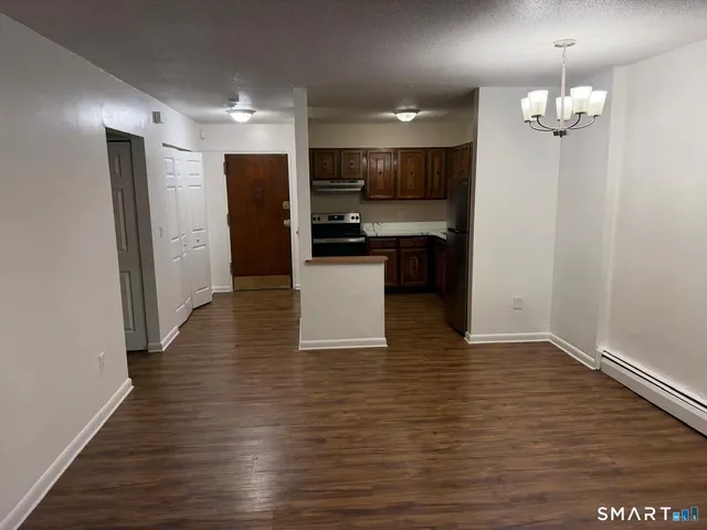a view of kitchen with sink and refrigerator