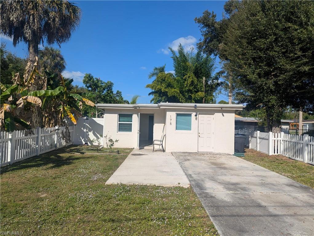 178 Evergreen Road North Fort Myers, FL 33903 - Photo 1 of 3 a view of a house with a yard and potted plants