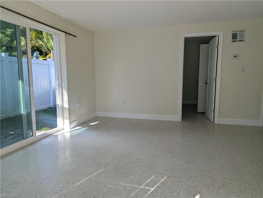 178 Evergreen Road North Fort Myers, FL 33903 - Photo 2 of 3 an empty room with sliding glass door and glass door