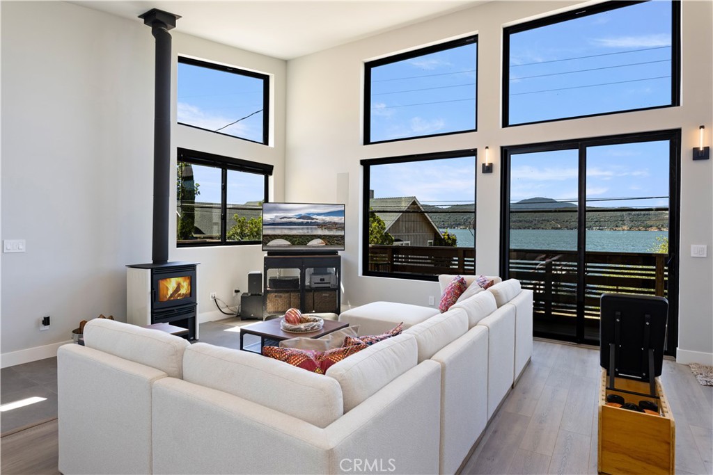 12630 Lakeshore Drive Clearlake, CA 95422 - Photo 12 of 73 a living room with fireplace furniture and floor to ceiling windows