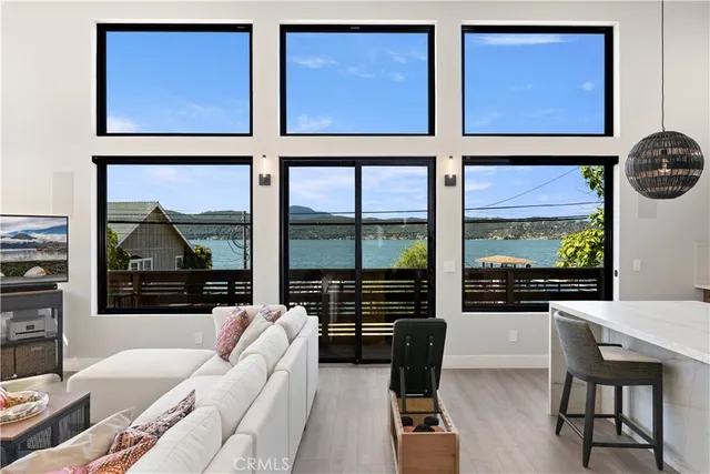 a kitchen with stainless steel appliances kitchen island a table chairs in it and wooden floors