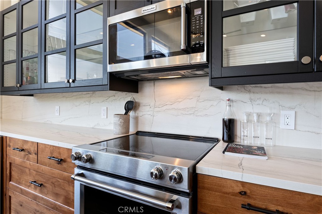 12630 Lakeshore Drive Clearlake, CA 95422 - Photo 19 of 73 a kitchen with a stove microwave and cabinets