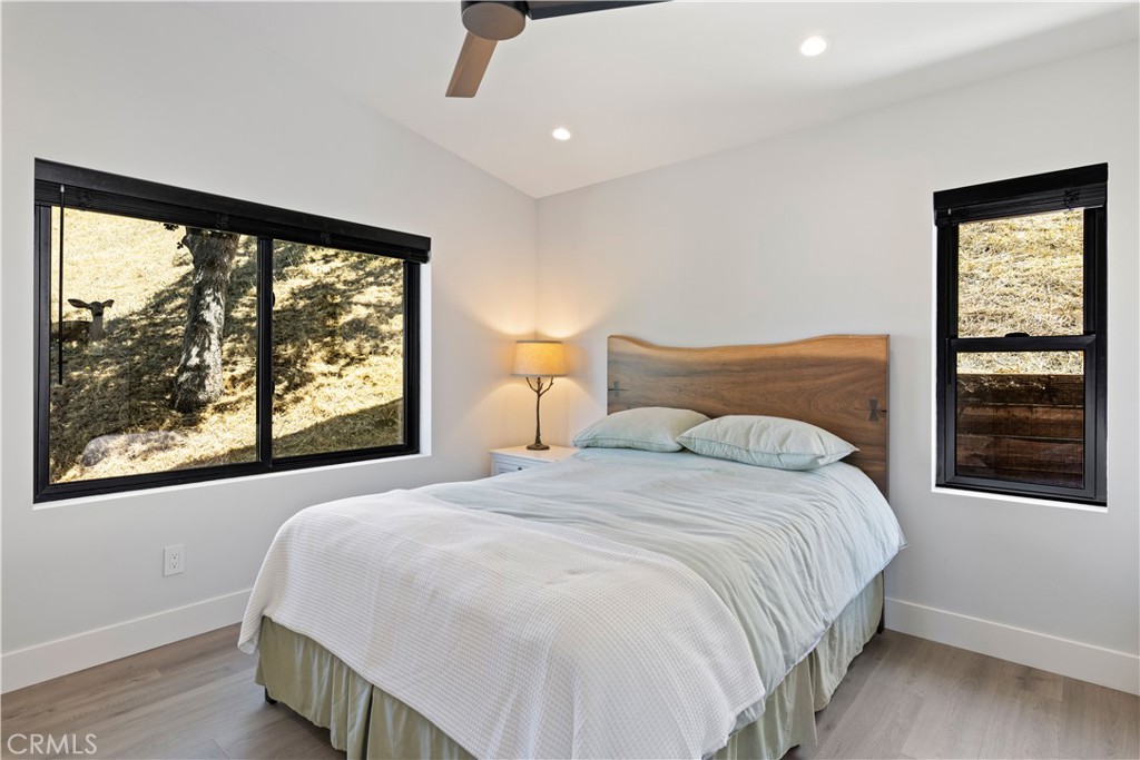 12630 Lakeshore Drive Clearlake, CA 95422 - Photo 25 of 73 a bedroom with a large bed and a large window