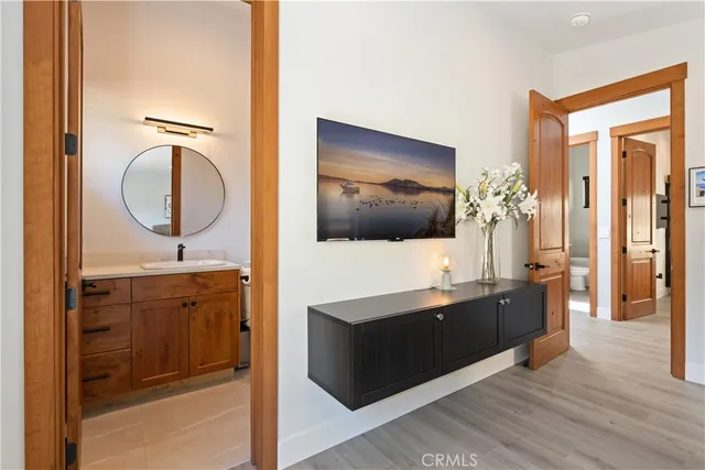 a kitchen with stainless steel appliances kitchen island granite countertop a table chairs in it and wooden floors