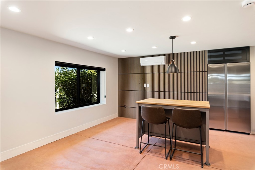 12630 Lakeshore Drive Clearlake, CA 95422 - Photo 37 of 73 a kitchen with a table chairs refrigerator and wooden floor