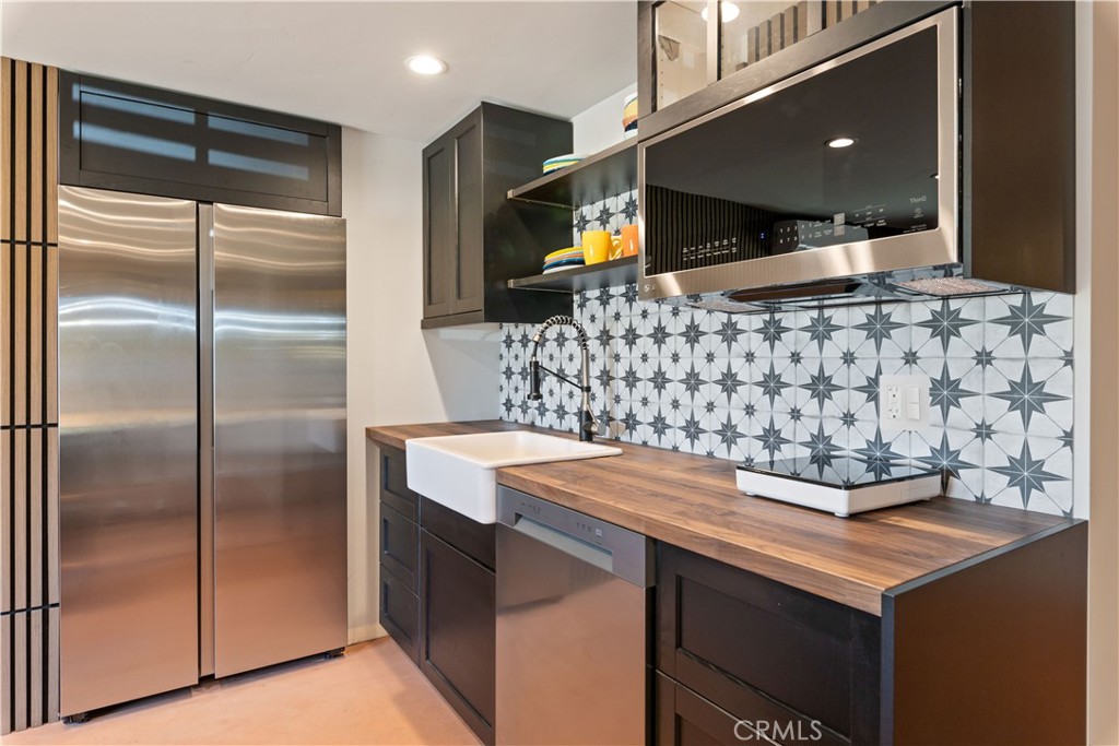 12630 Lakeshore Drive Clearlake, CA 95422 - Photo 40 of 73 a kitchen with stainless steel appliances kitchen island granite countertop a refrigerator and a stove