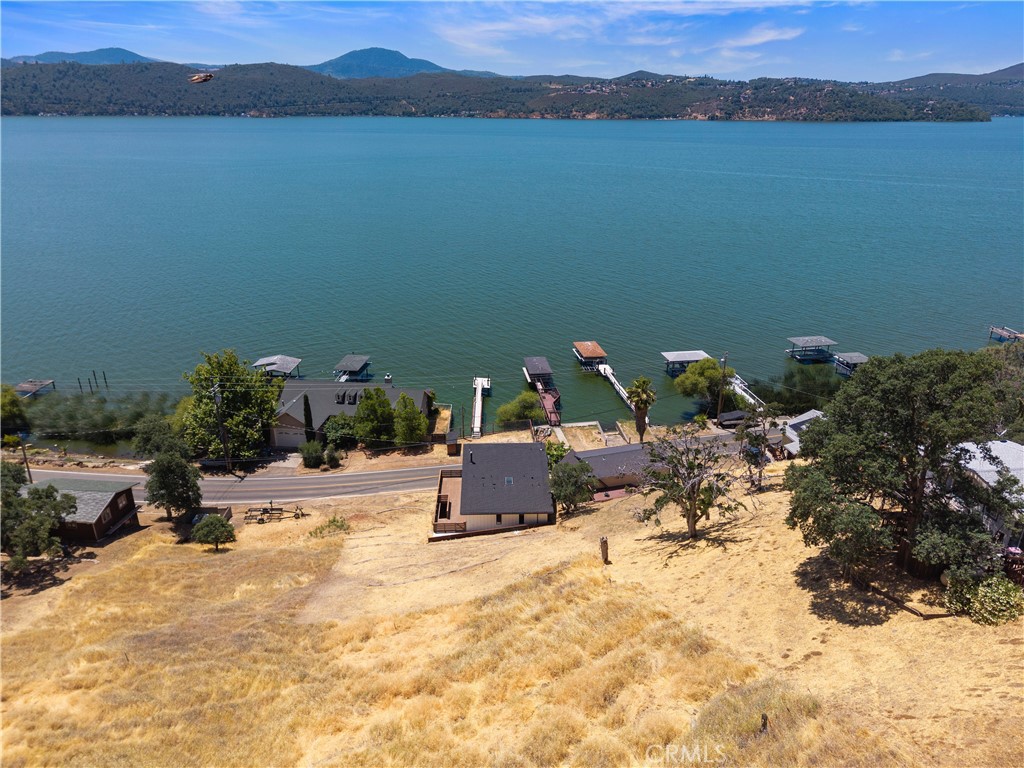 12630 Lakeshore Drive Clearlake, CA 95422 - Photo 69 of 73 a wooden bench sitting in the middle of a lake