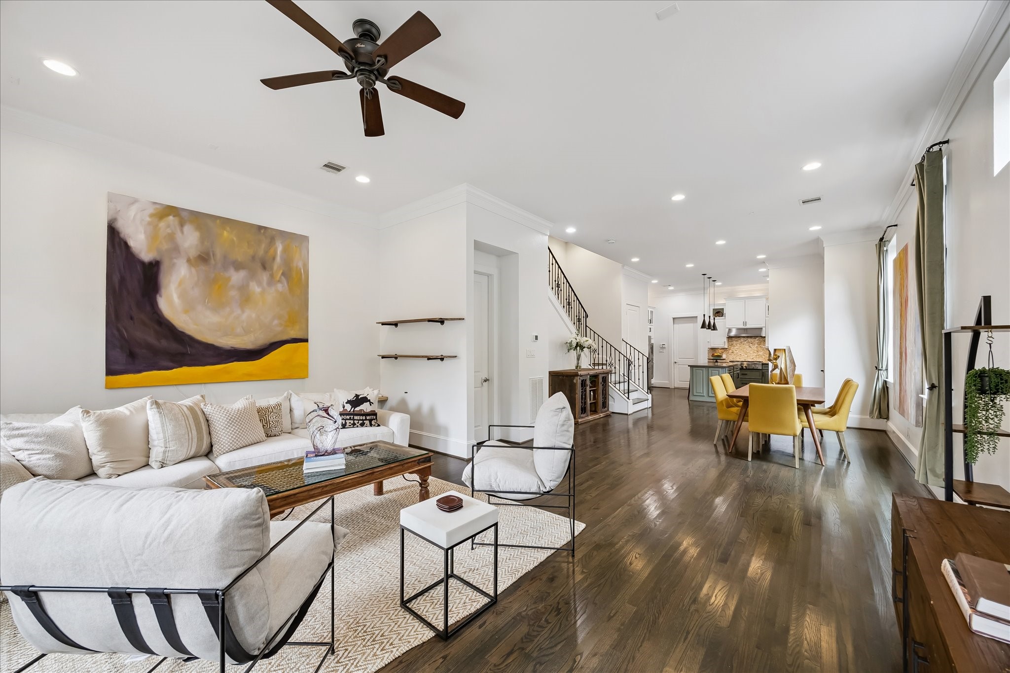 1208 Welch Street Houston, TX 77006 - Photo 11 of 35 The main living floor is wide open, but still has design features that delineate the spaces--the stairway and dry bar, half-bath beside the stairs, and staggered wall at right back.