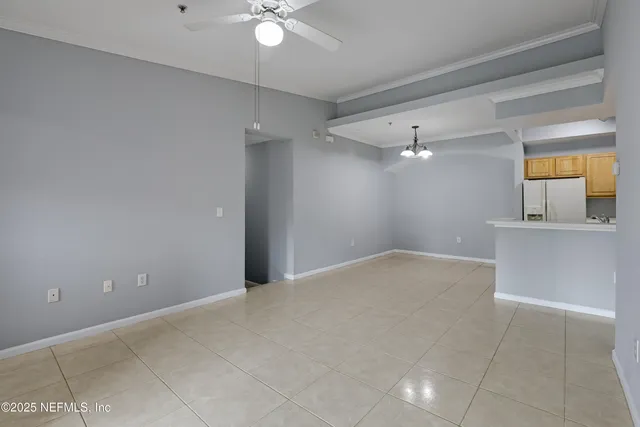 a view of a livingroom with a ceiling fan and window