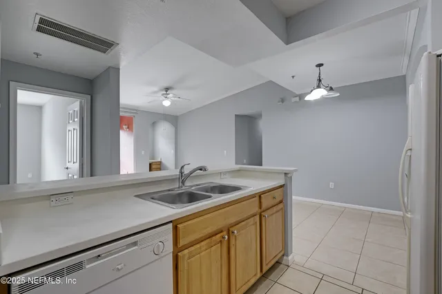 a kitchen with a sink and a mirror