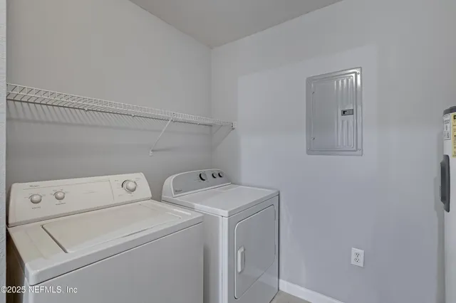 a view of storage and utility room with washer and dryer