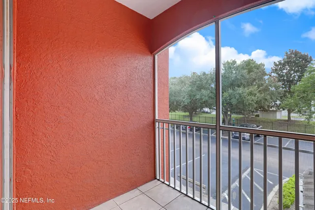 a view of a glass door with a yard from a balcony
