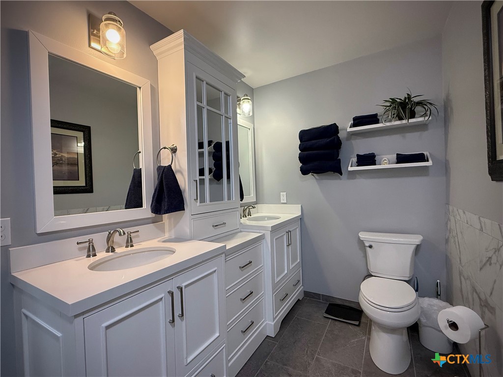 2701 Leary Lane Victoria, TX 77901 - Photo 28 of 48 a bathroom with a toilet sink and mirror
