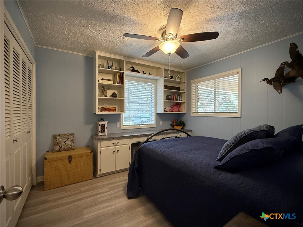 2701 Leary Lane Victoria, TX 77901 - Photo 30 of 48 a bedroom with a bed and a chandelier