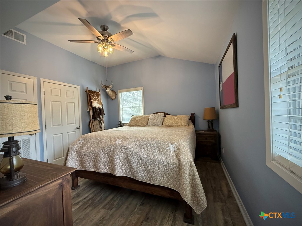 2701 Leary Lane Victoria, TX 77901 - Photo 38 of 48 a bedroom with a bed and a chandelier