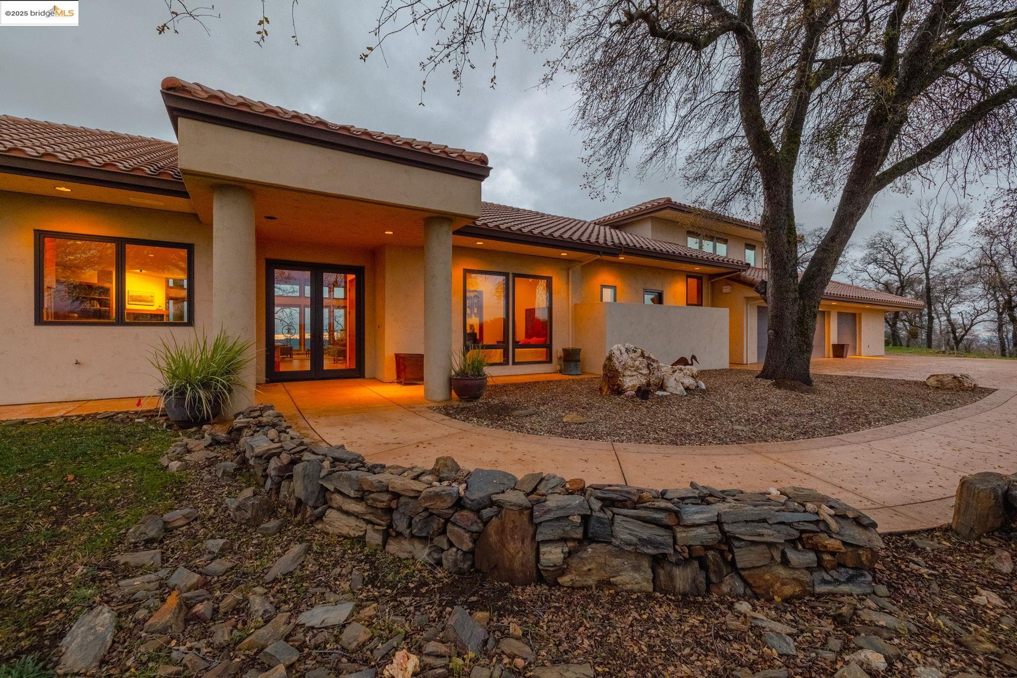 25775 Powell Ranch Road Sonora, CA 95370 - Photo 1 of 60 a view of a house with backyard and sitting area
