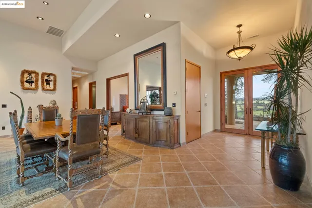 a dining room with furniture and a floor to ceiling window