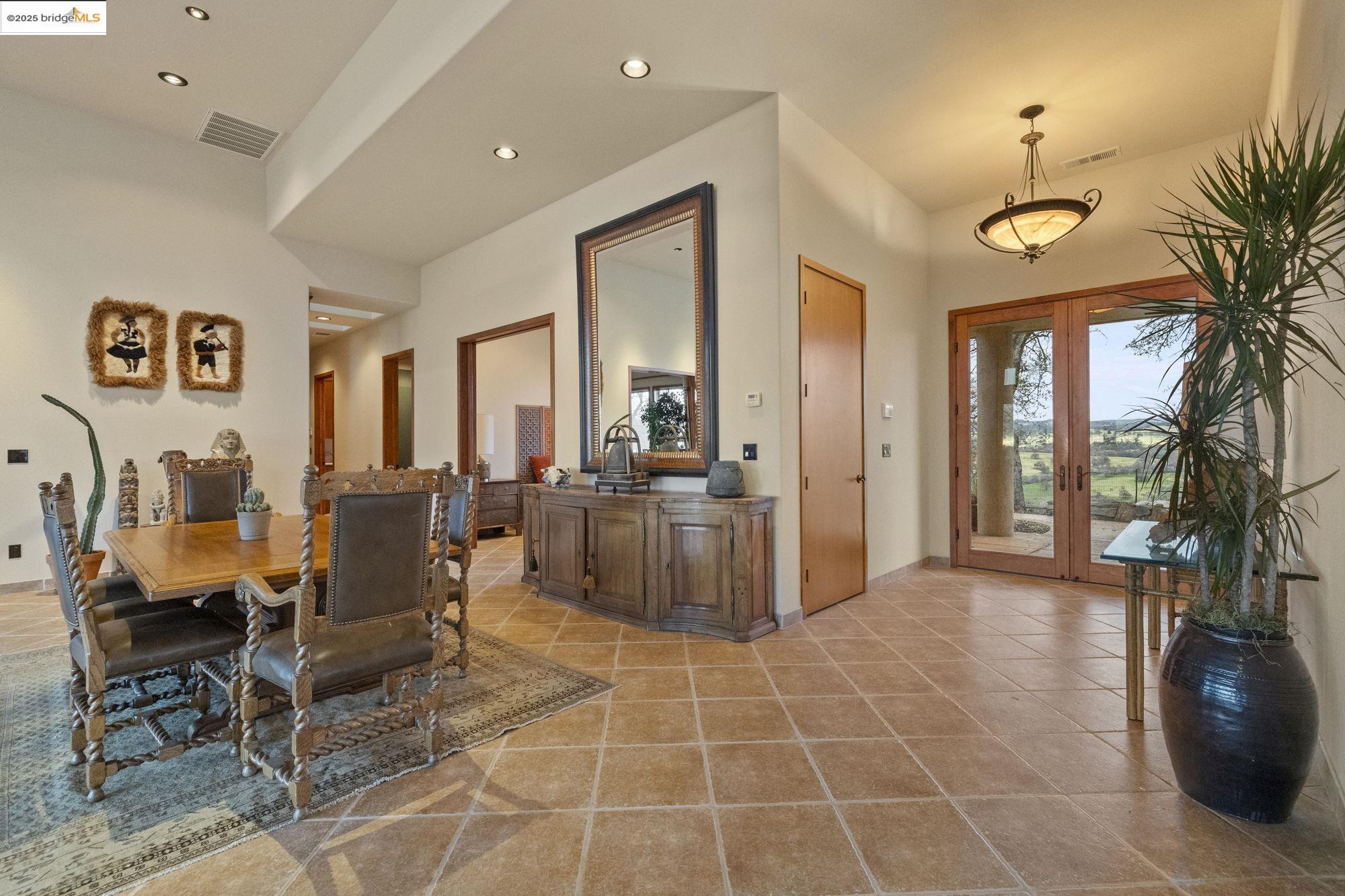 25775 Powell Ranch Road Sonora, CA 95370 - Photo 11 of 60 a living room with furniture a dining table and a potted plant