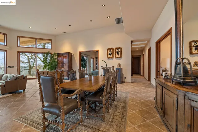 a dining room with furniture a chandelier and wooden floor