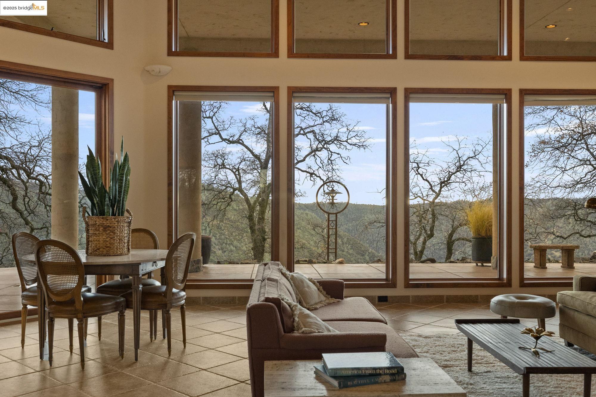 25775 Powell Ranch Road Sonora, CA 95370 - Photo 14 of 60 a living room with furniture and floor to ceiling windows