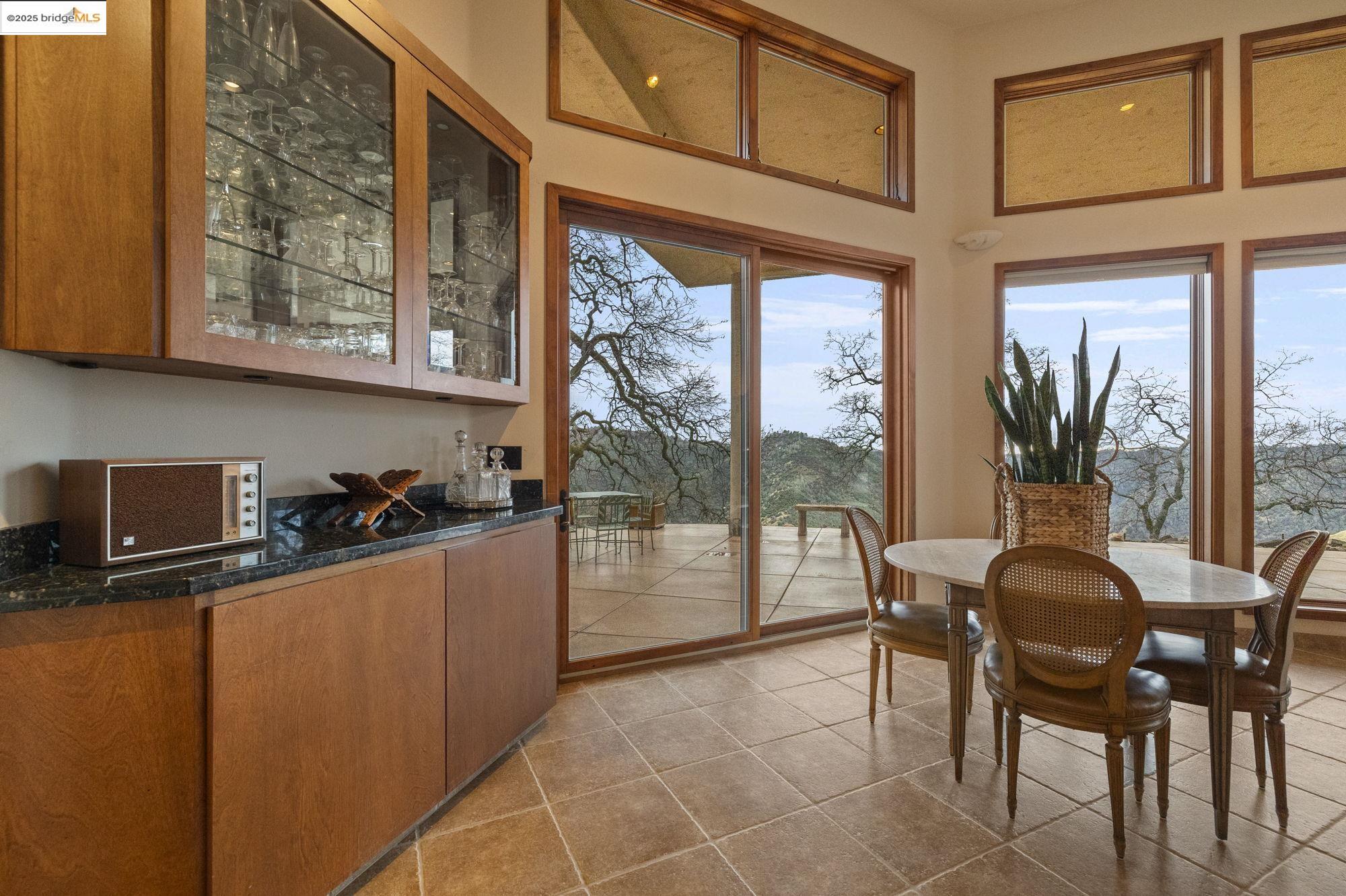 25775 Powell Ranch Road Sonora, CA 95370 - Photo 15 of 60 a dining room with furniture and a floor to ceiling window