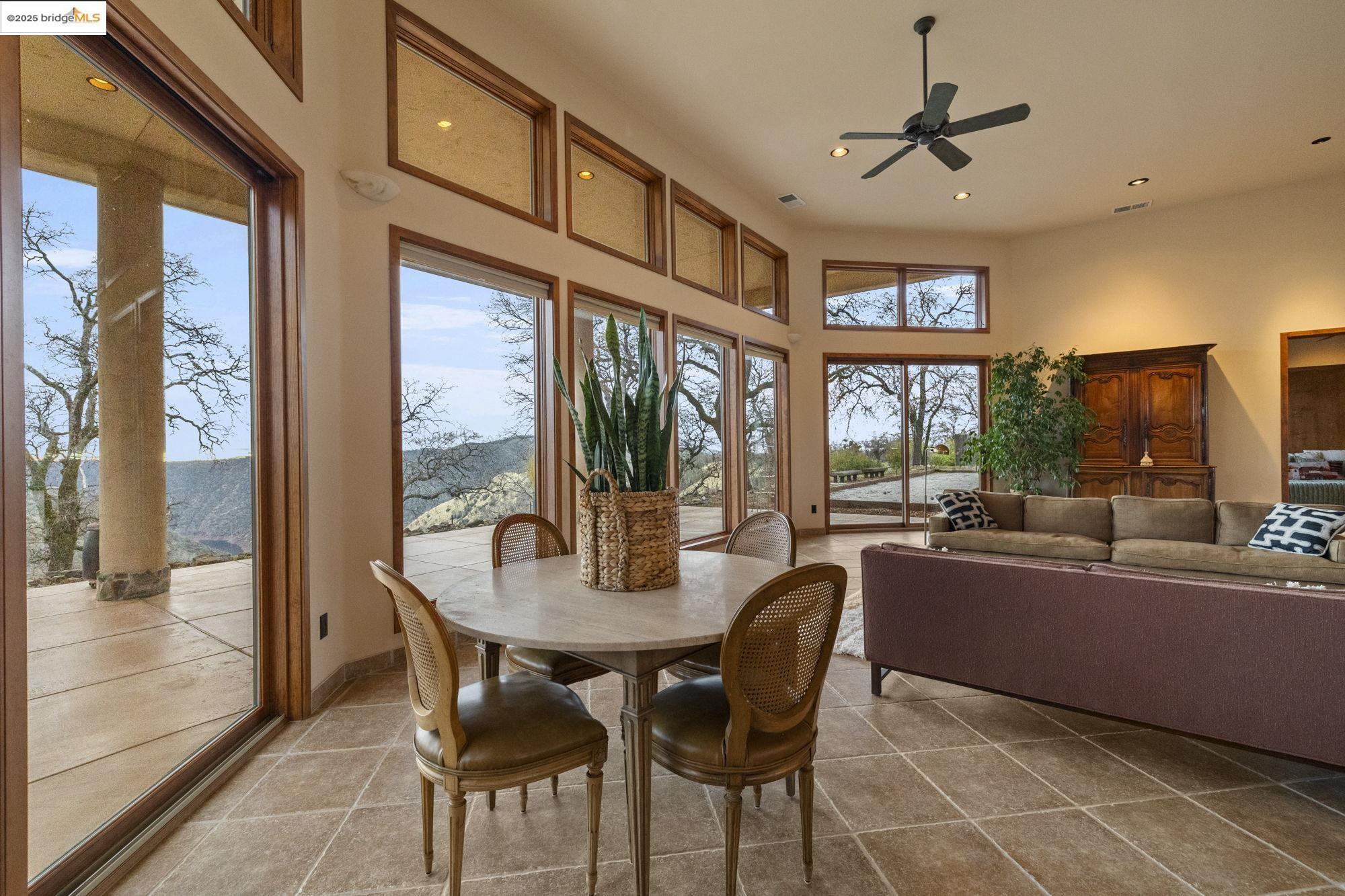 25775 Powell Ranch Road Sonora, CA 95370 - Photo 16 of 60 a dining room with furniture a chandelier and wooden floor