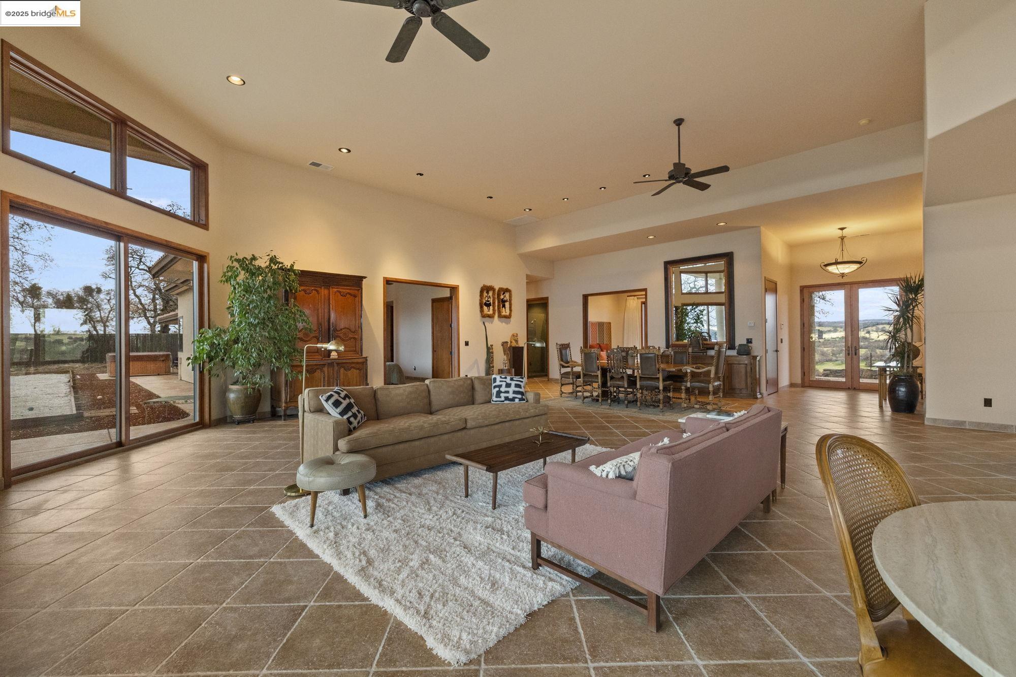 25775 Powell Ranch Road Sonora, CA 95370 - Photo 17 of 60 a living room with furniture a rug and a large window