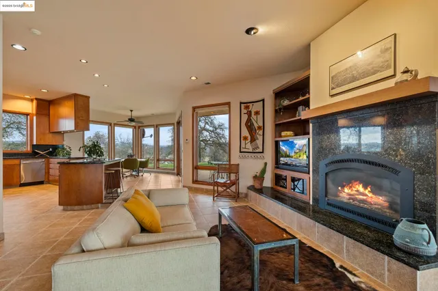a kitchen with stainless steel appliances granite countertop a refrigerator and a stove