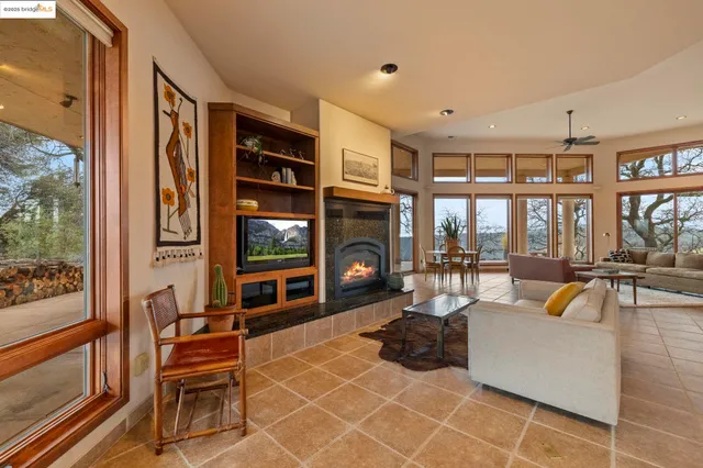 a dining room with furniture water view and a floor to ceiling window