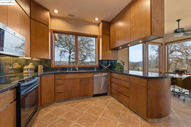 a large bedroom with a bed and a large window