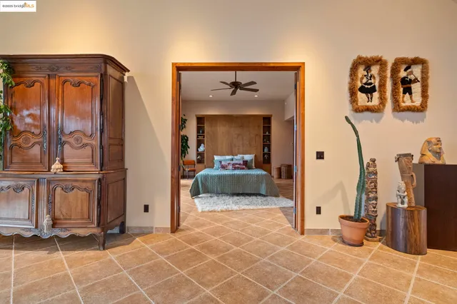 a bedroom with a bed and large window