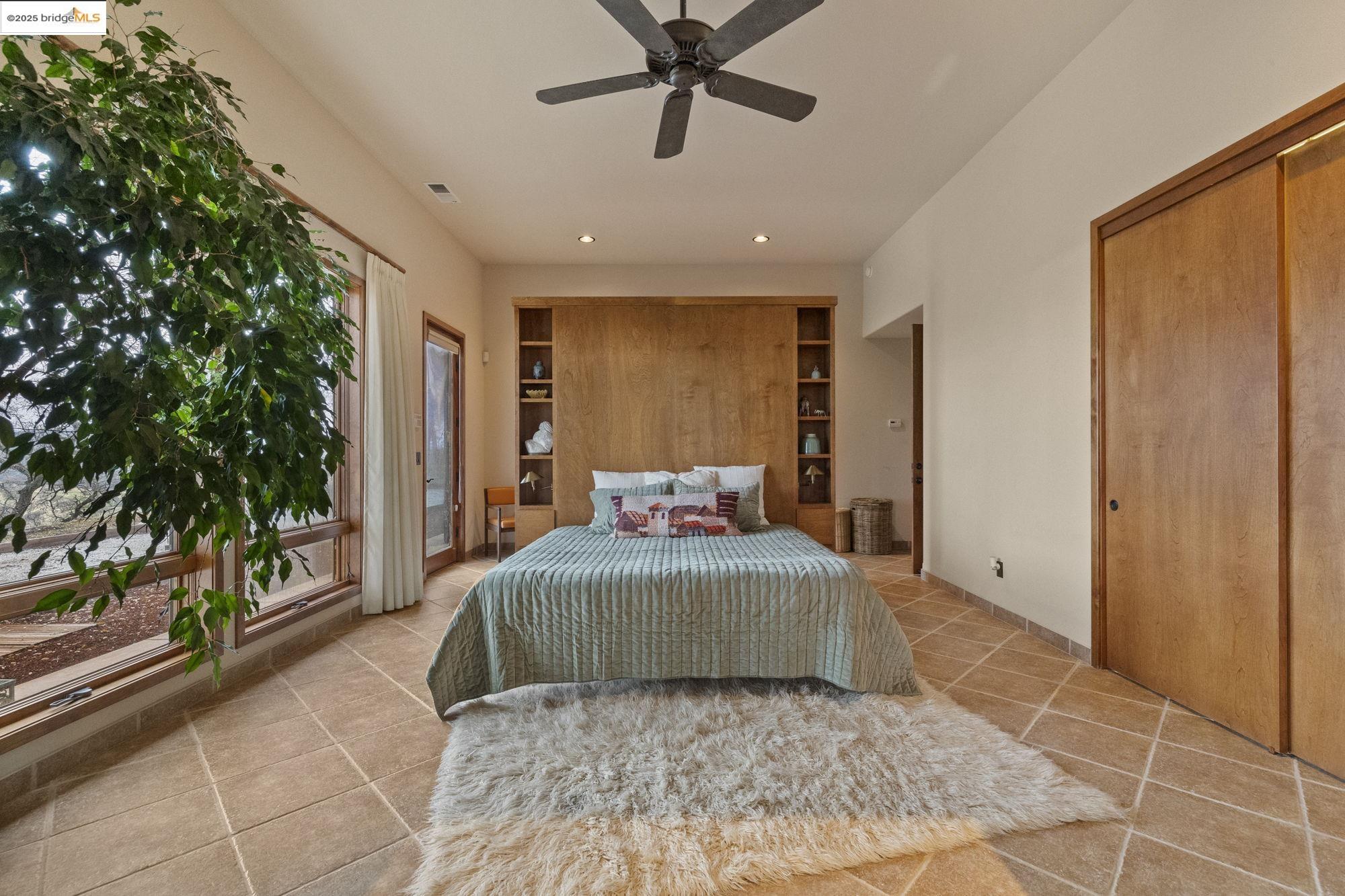 25775 Powell Ranch Road Sonora, CA 95370 - Photo 28 of 60 a large bedroom with a bed and a large window