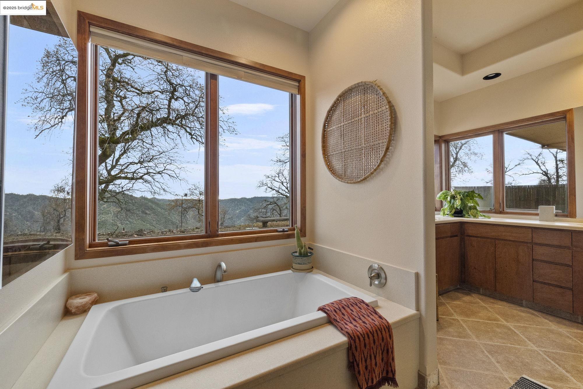 25775 Powell Ranch Road Sonora, CA 95370 - Photo 31 of 60 a living room with a large window and a table