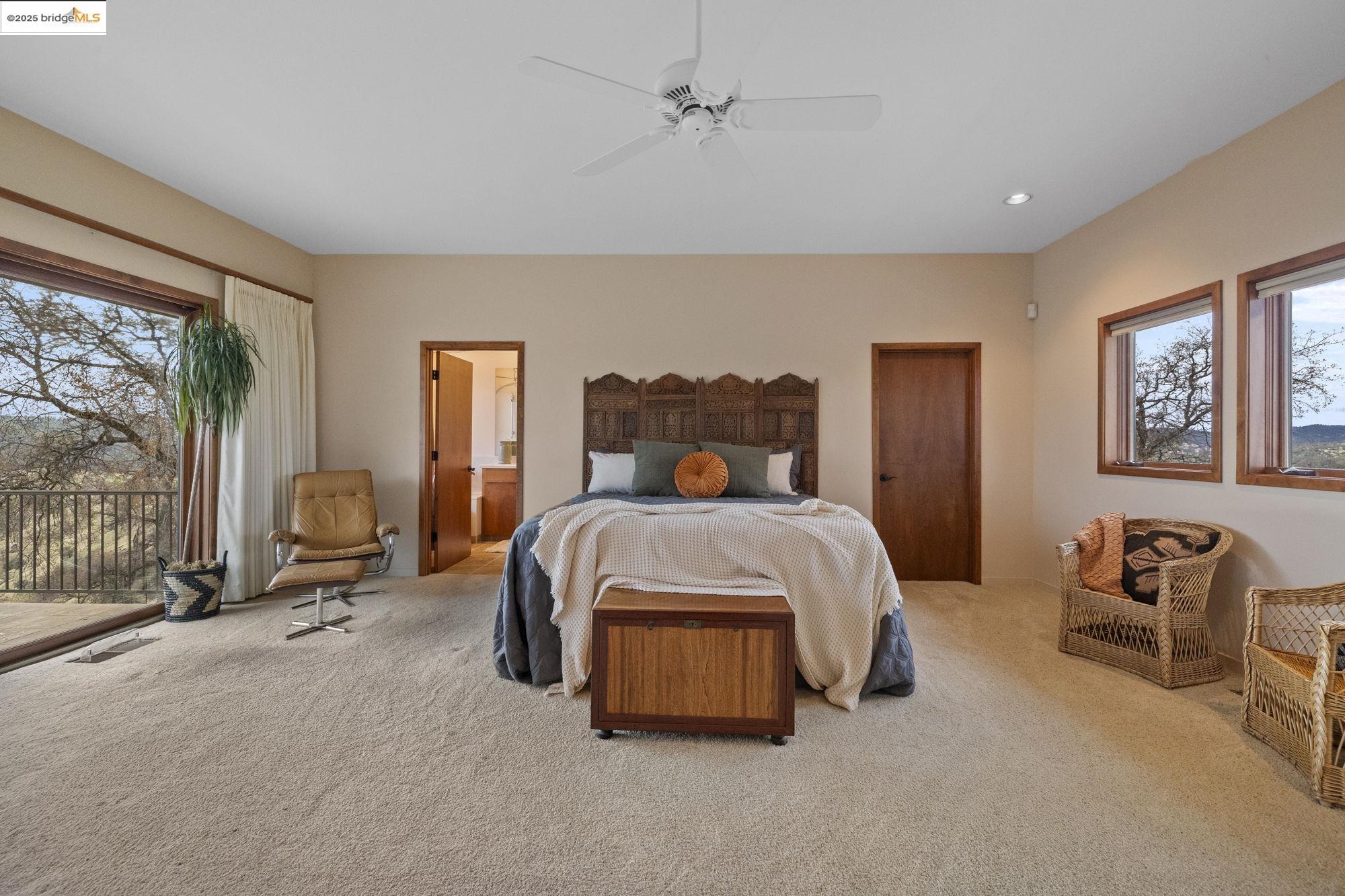 25775 Powell Ranch Road Sonora, CA 95370 - Photo 35 of 60 a bedroom with a bed and large windows