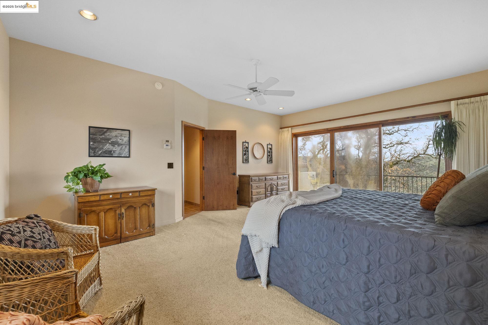 25775 Powell Ranch Road Sonora, CA 95370 - Photo 36 of 60 a bedroom with a large bed and a dresser