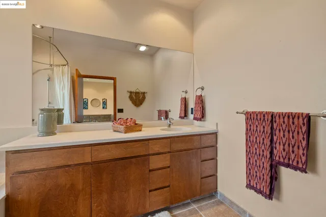 a view of a patio with table and chairs with wooden floor and fence