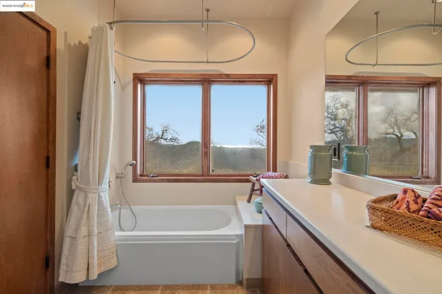 a view of a patio with a table and chairs under an umbrella