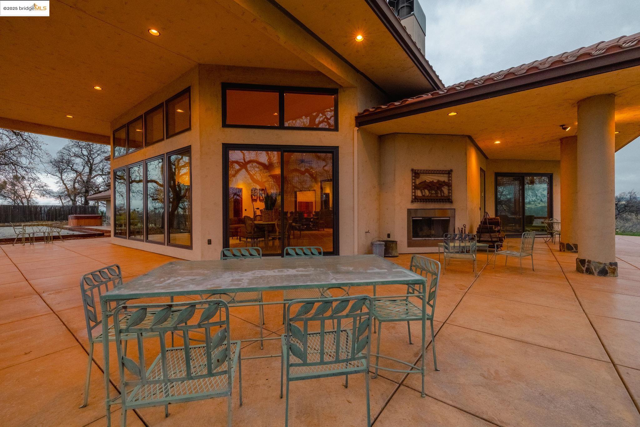 25775 Powell Ranch Road Sonora, CA 95370 - Photo 4 of 60 a view of a patio with table and chairs with wooden floor and fence